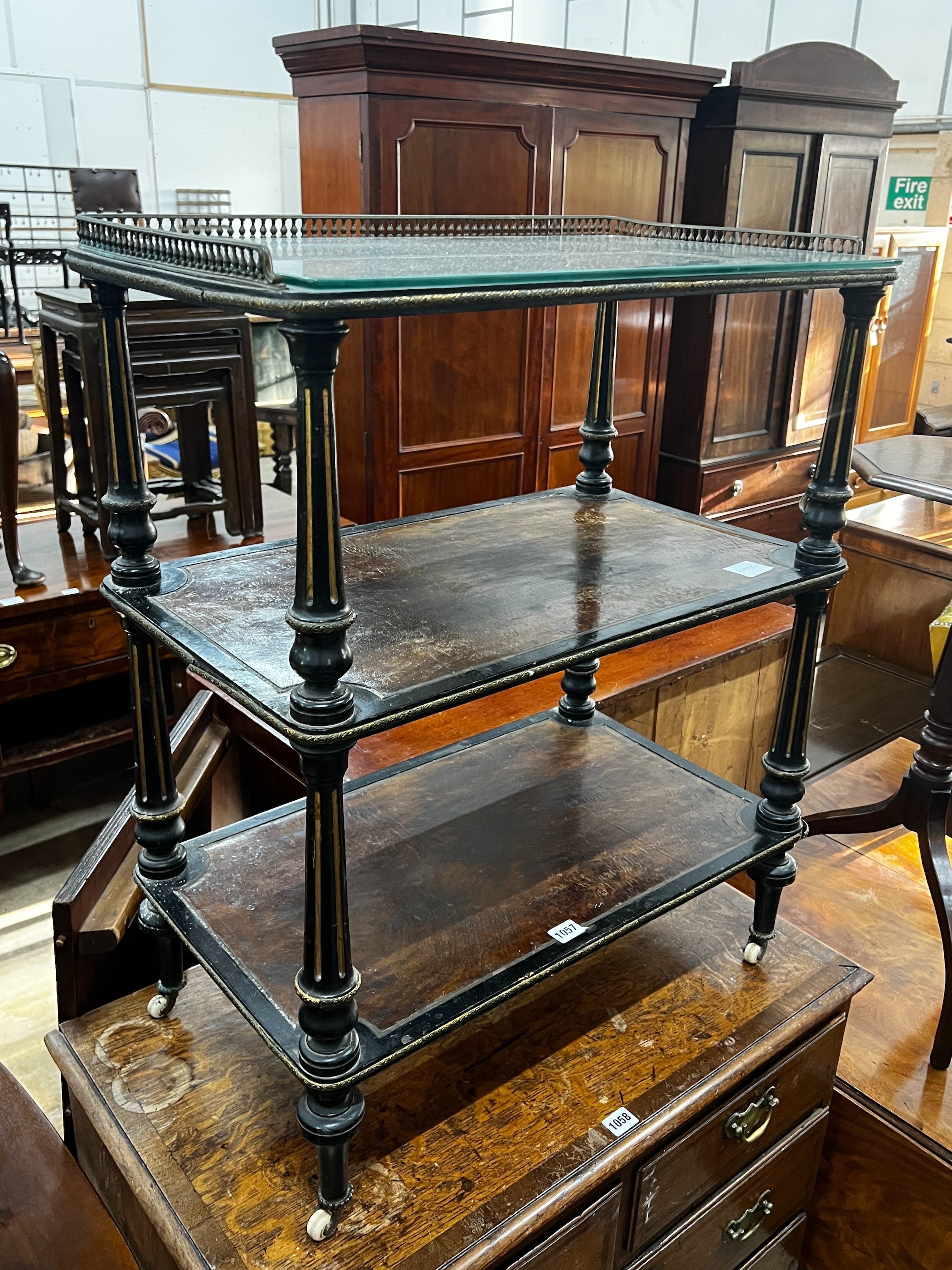 A late Victorian ebonised and amboyna three tier whatnot, width 66cm, depth 39cm, height 81cm